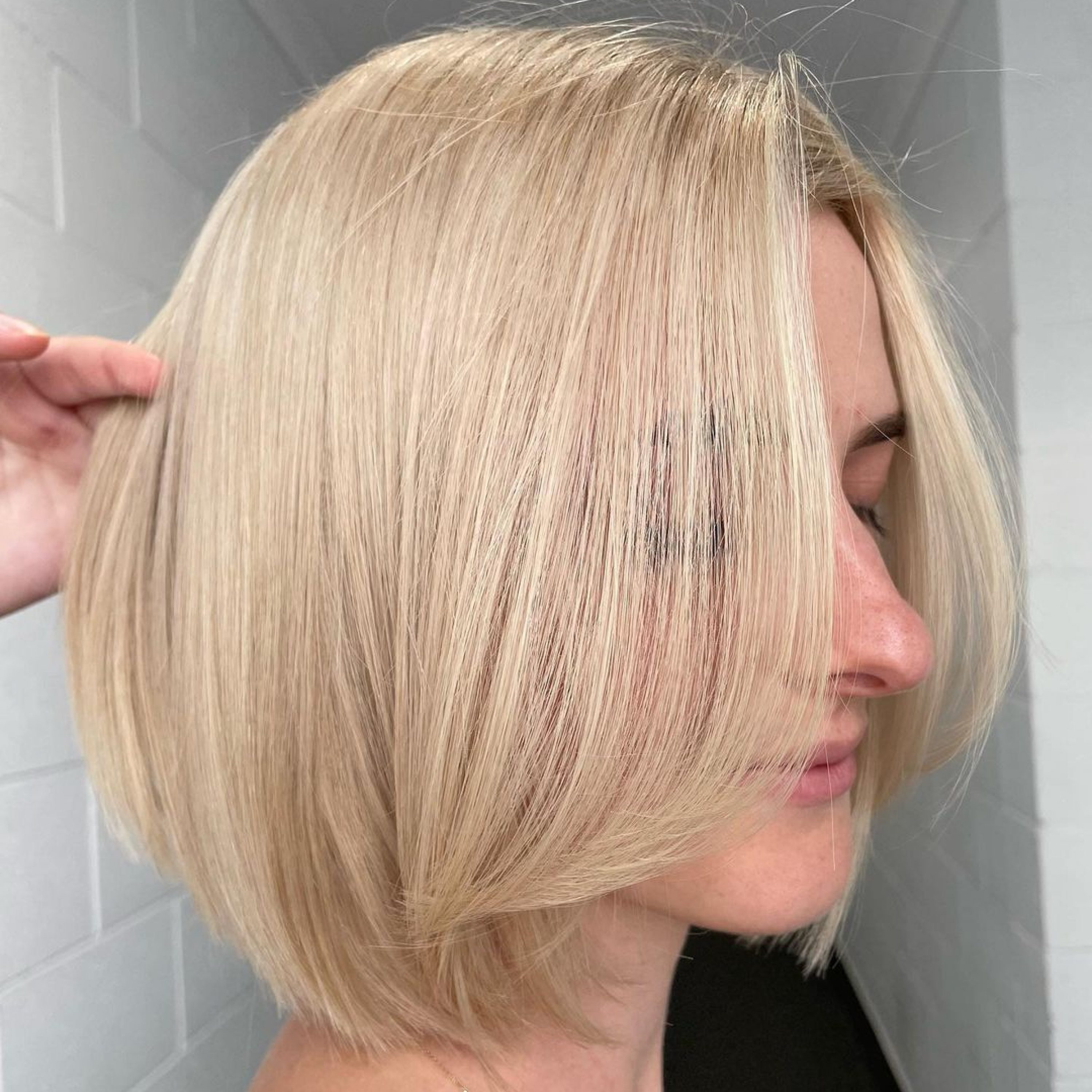 beige blonde bob with long bangs