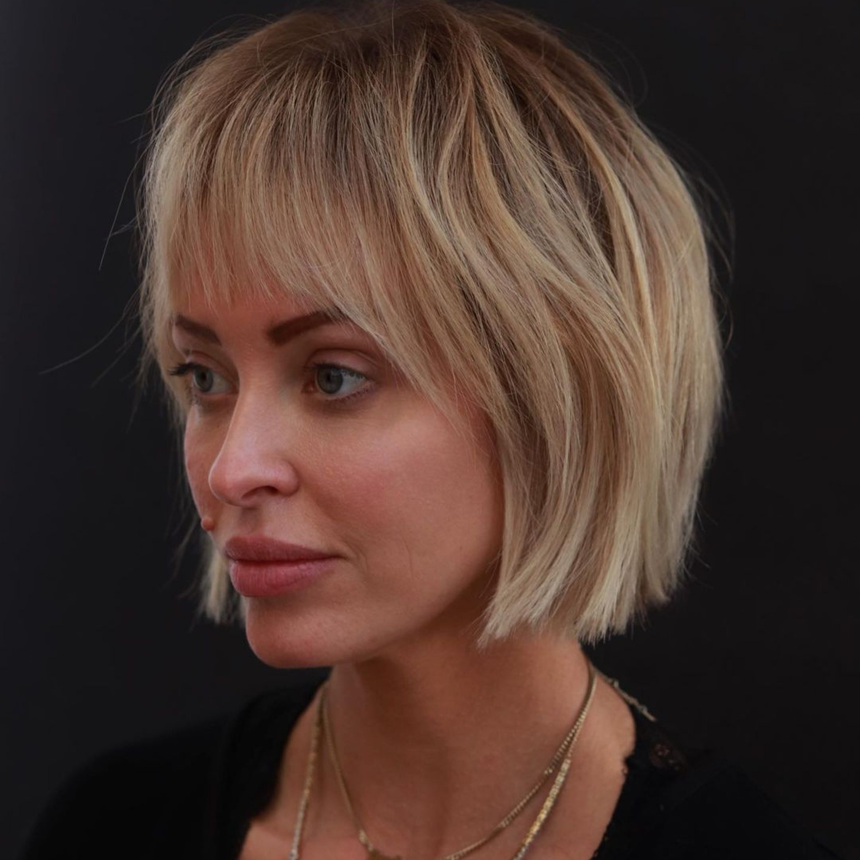 voluminous short blonde bob with bangs