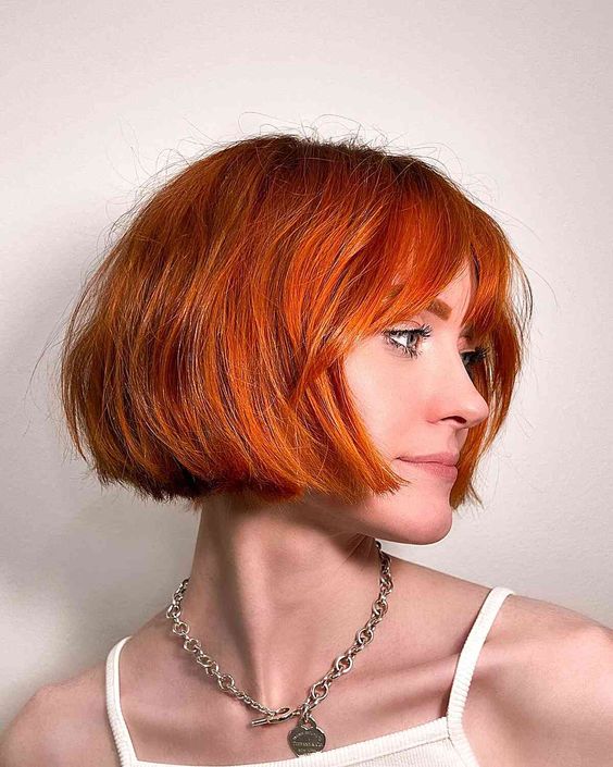 a stunning jaw-length bob with wispy bangs is a gorgeous idea to make a statement with color and shape