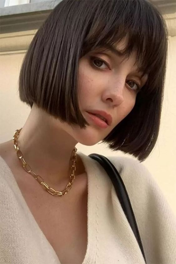 a timeless jaw-length brunette bob with wispy bangs is a cool idea that never goes out of style