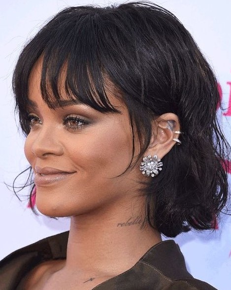 Rihanna rocking a black chin-length bob with messy waves and wispy bottleneck bangs looks jaw-dropping