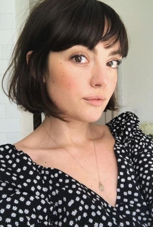 an almost black French bob with wispy and bottleneck bangs is a cool and chic idea to try right now