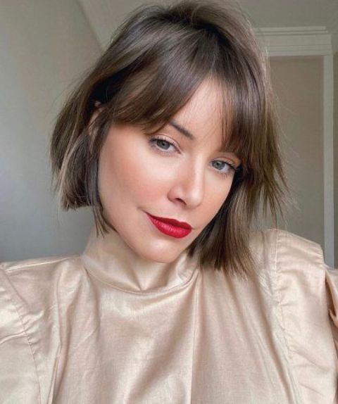 a brunette bob bob with bottleneck bangs and a bit of texture is a cool and fresh idea for trying now