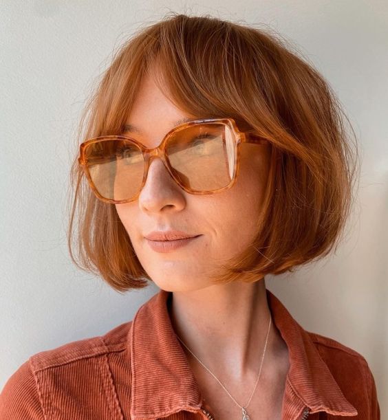 a beautiful short ginger bob with bottleneck bangs looks very lively, cute and chic and will add color to your look