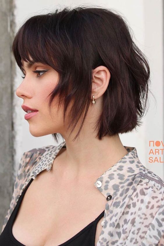 a dark chestnut shaggy and layered short bob with bottleneck bangs is a bold and catchy idea