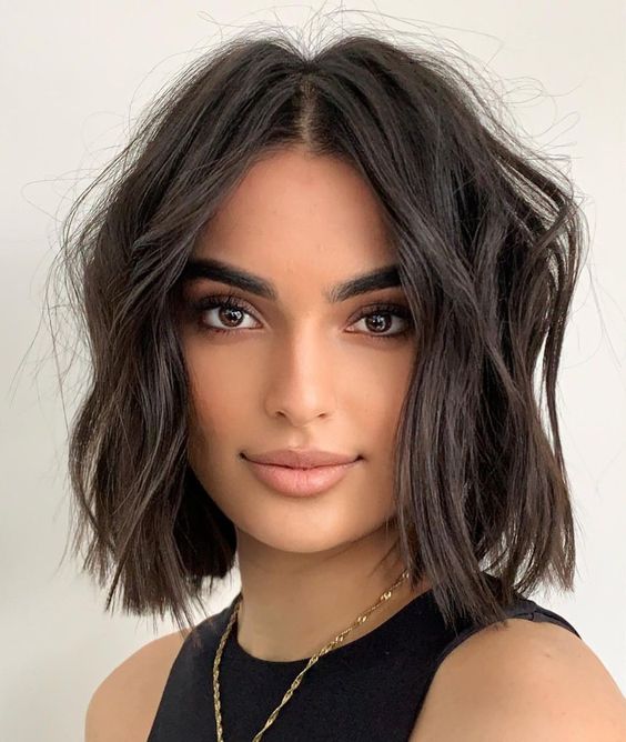 a dark brown messy wavy lob with a lot of volume is a cool and catchy idea that looks chic