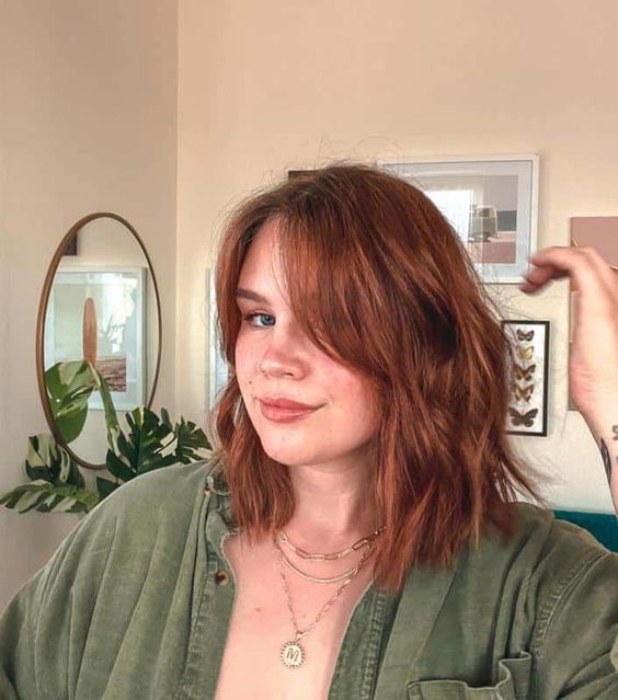 a gorgeous ginger long bob with curtain bangs and messy waves is a stunning idea to look bold and catchy