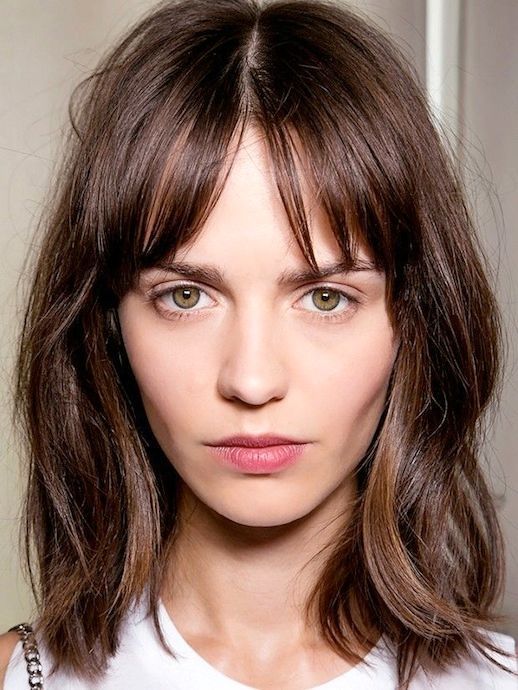 a messy layered brown shoulder-length bob with highlights and bottleneck bangs is a lovely idea to wear right now