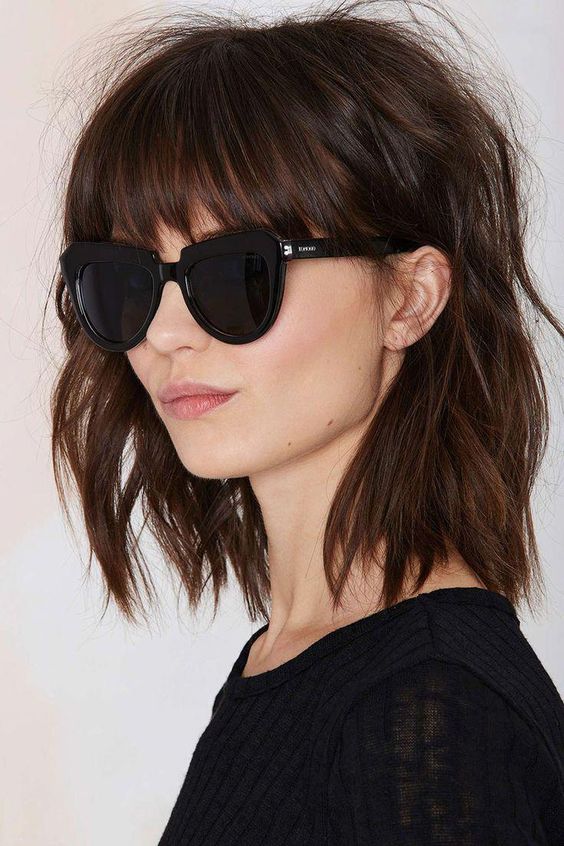 a shaggy brown shoulder-length bob with classic bangs and messy waves is a very rock-n-roll idea to rock