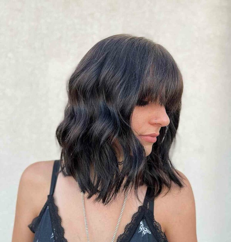 a medium haircut with bangs and waves will highlight your sexy collarbones