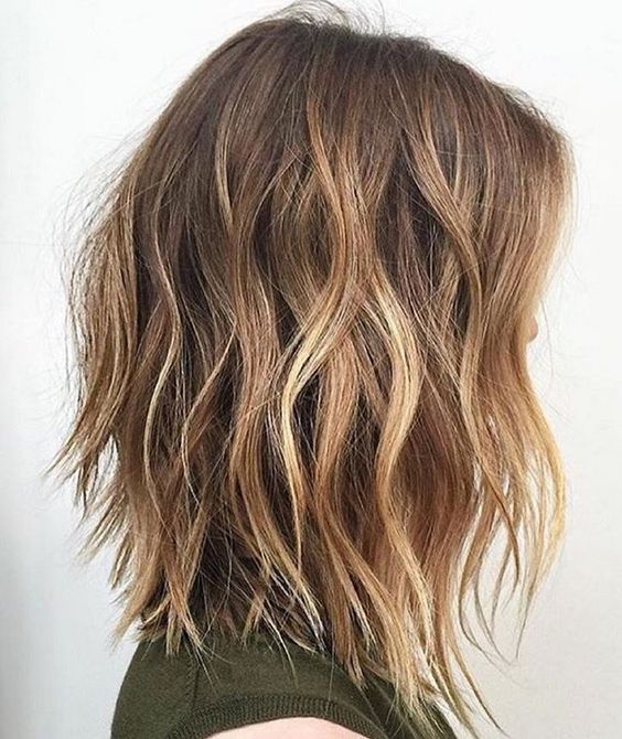 beautiful shaggy and choppy brown hair with blonde balayage and beach waves is a fantastic idea for the summer