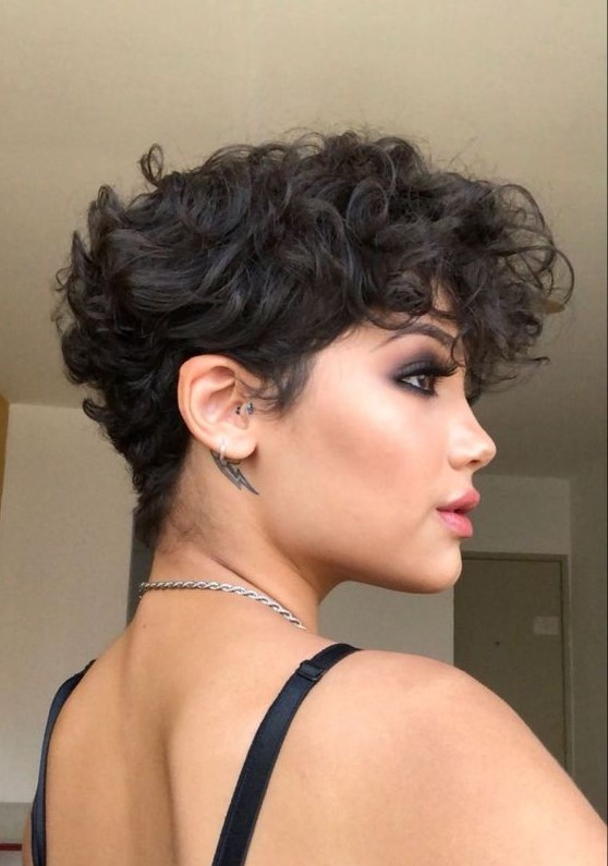 a bold black wavy pixie with a lot of volume and longer bangs is a very beautiful and eye-catching idea to try