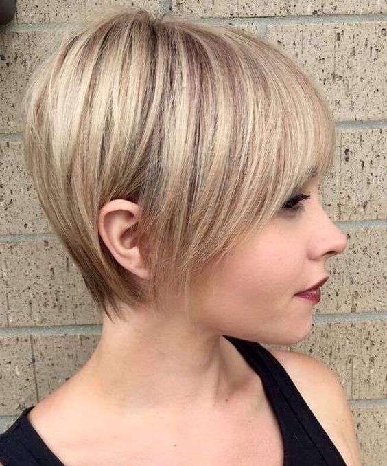 a longer pixie haircut with sleek styling and a light blondie balayage