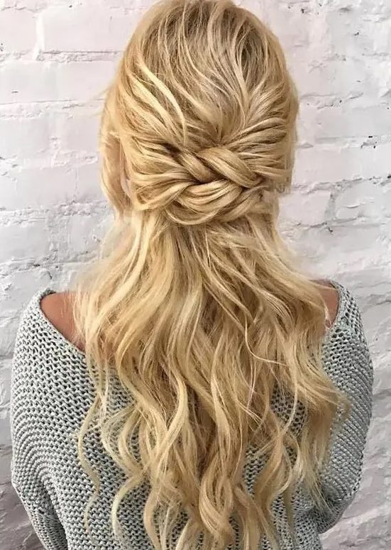 an eye-catchy half updo with a bump on top and a double twisted element, some waves down is a stylish and chic idea