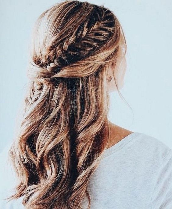 a half updo with waves and a single side braid tucked into the twists is a chic idea