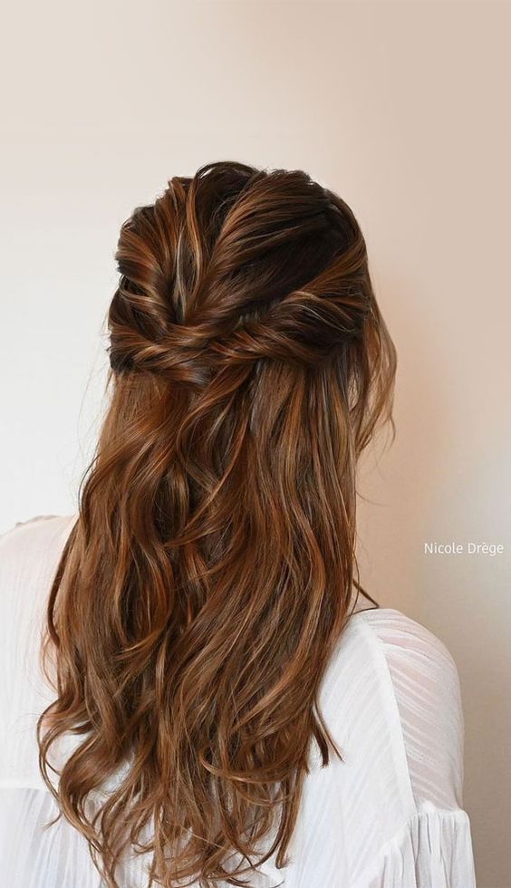 an elegant long half updo with twists on top and sides and waves down is a cool idea for a holiday party