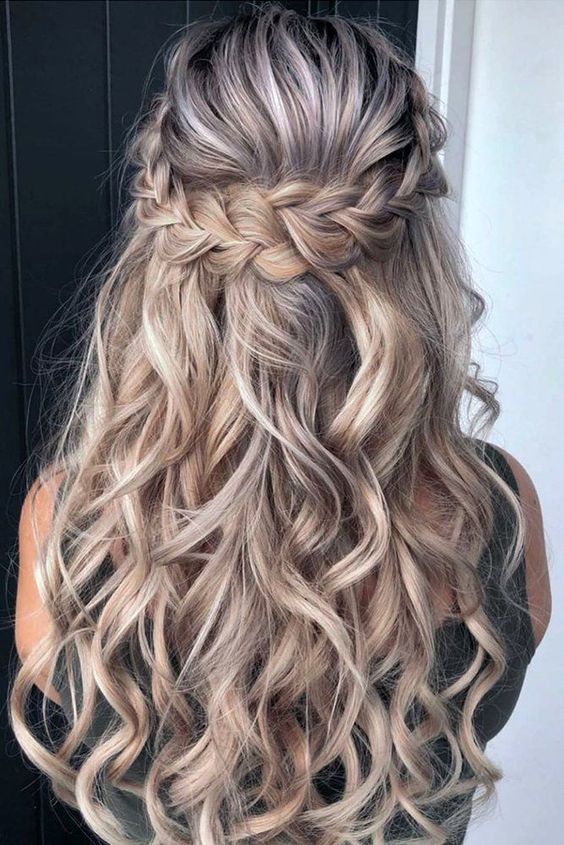 a lovely half updo with a braided halo and waves down is a cool and catchy solution that will work for many occasions