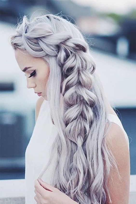 long wavy hair down with a large side fishtail braid is a gorgeous holiday statement