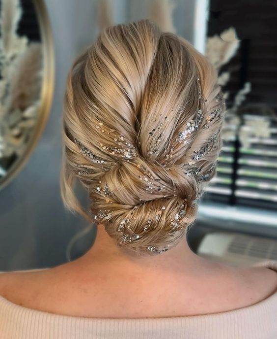 a fantastic twisted updo with a lot of volume and silver glitter right on the hair is a wow solution for the holidays