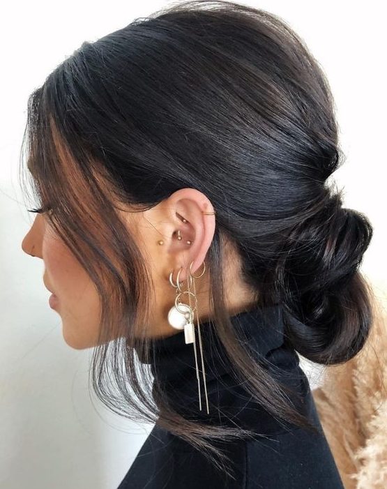 a low knot with a bump on top and some hair framing the face is a catchy and lovely idea for anyone