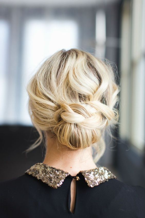 a pretty low updo with a braided touch and a wavy and mess top is a cool solution for a Christmas look