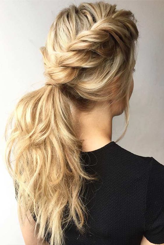 a low ponytail made of two twisted side braids, with waves and a bump plus bangs