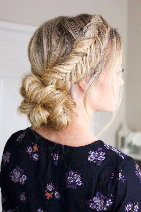 a low bun with two fishtail side braids and a bump is a chic and comfy to wear option