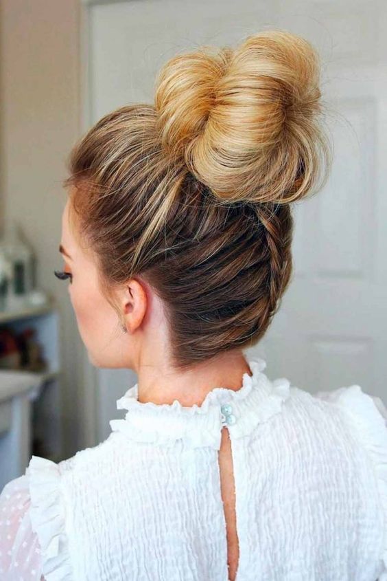 an elegant top knot with a bump and a braid on the back is a cute and fun option