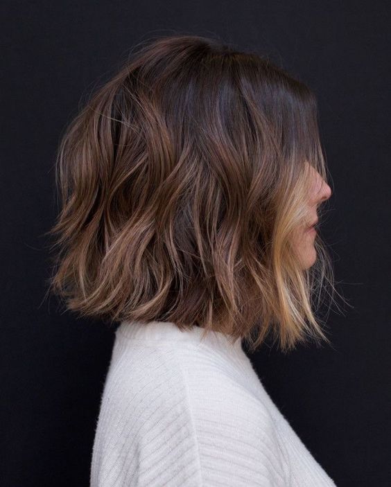 a dark brunette long bob with caramel highlights and a blonde money piece is a lovely and chic solution