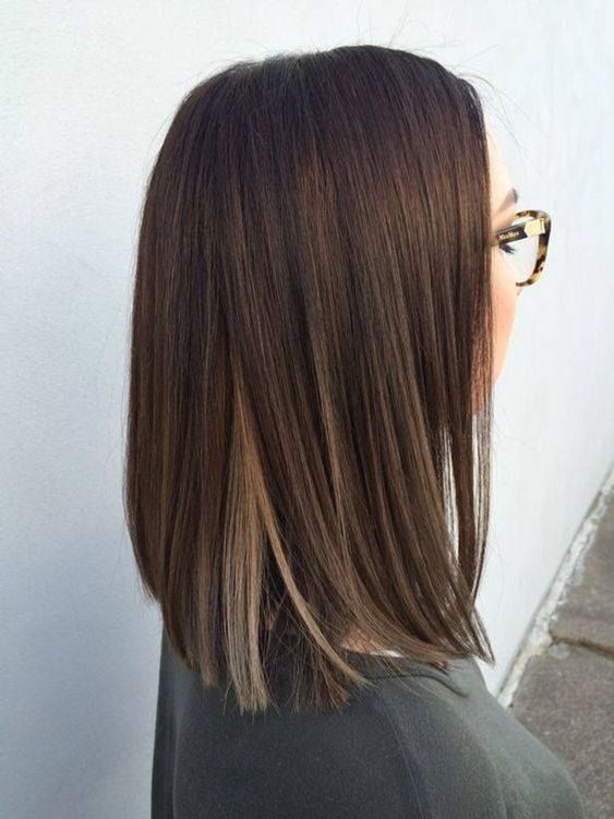 a stylish dark brunette long bob with blonde touches underneath is a cool idea, and blodne highlights will make your look stand out